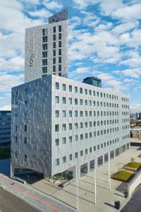 a large white building with a sign on the side of it at Fosshotel Reykjavík in Reykjavík