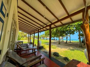 a porch with benches and a view of the ocean at Bliss Bay Beach Resort & Spa in Nilaveli