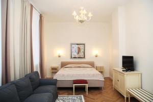 a living room with a bed and a couch at Audeju Apartments in Riga