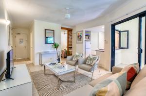 a living room with a couch and a table at Freestyle Resort Port Douglas in Port Douglas +17 photos