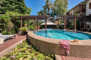 a swimming pool in the middle of a building at Freestyle Resort Port Douglas in Port Douglas