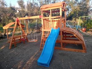 a playground with a slide and a swing at La Vecchia Lanterna in Montecorvino Rovella