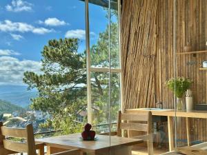 a teddy bear sitting on a table in front of a window at Stardome Apartment Dalat in Ấp Ða Lợi