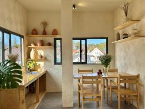 a kitchen and dining room with a table and chairs at Stardome Apartment Dalat in Ấp Ða Lợi