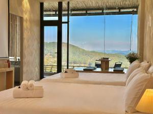 a bedroom with a large bed with towels on it at Stardome Apartment Dalat in Ấp Ða Lợi