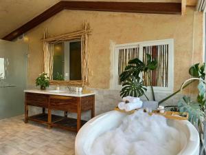 a large bathroom with a tub and a sink at Stardome Apartment Dalat in Ấp Ða Lợi +100 photos