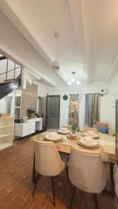 a dining room with a table and chairs at Mellow Place Staycation in Naic
