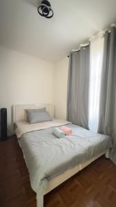a bedroom with a bed with a canopy and a window at Mellow Place Staycation in Naic