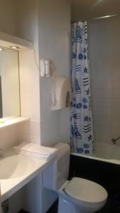 a bathroom with a sink and a toilet and a shower at Hotel Queen Mary in Brussels +79 photos