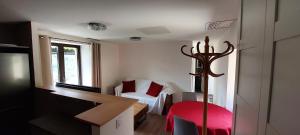 a small room with a bed and a red stool at Gîte de Laulagne in Ribes