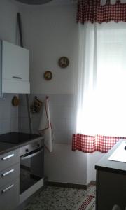 a kitchen with a sink and a stove top oven at Appartamento Piazza Buzi in Orvieto