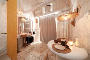 a bathroom with a white sink in a room at Suite Amor in Alberobello