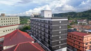 a building with a clock tower on top of it at SleepRest Azure Suites in Bagam