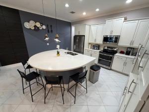 a kitchen with a table and chairs in it at 5BR Getaway with Pool Arcade Games and Resort Access in Davenport