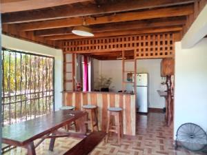 a dining room with a wooden table and chairs at Casa Almendros in Cabuya