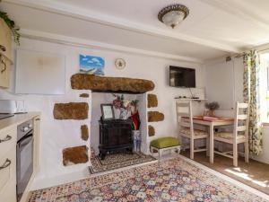 a kitchen with a stone fireplace and a table at Longview Cottage in Bugle +6 photos