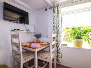 a room with a table and two chairs and a window at Longview Cottage in Bugle