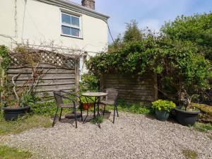 a table and chairs in the garden of a house at Longview Cottage in Bugle