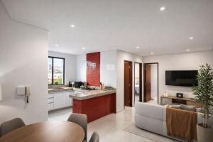 a kitchen and living room with a couch and a table at Super Apt morada do Vale in Governador Valadares