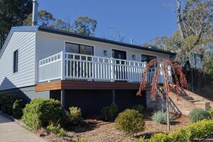a house with a balcony on the side of it at La Villa Dolce in Mount Victoria