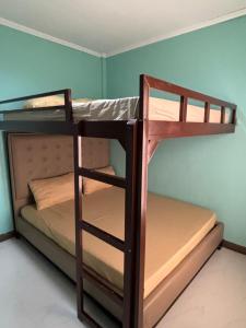 two bunk beds in a room with a blue wall at Three Bedrooms Comfort Zone Guesthouse in Bengcag