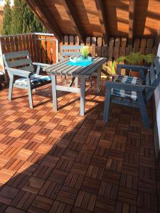a patio with two benches and a table and chairs at Ferienwohnung-Loesch in Neuenburg am Rhein