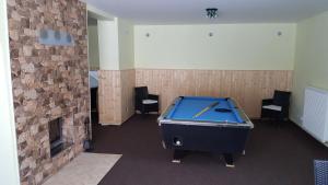 a room with a pool table and a fireplace at Prázdninový dům Josefův Důl in Josefuv dul