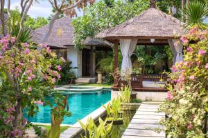 a resort with a swimming pool and a gazebo at Villa Seriska Satu Sanur,a Luxury 4-Bedroom Villa, 5 mins walk to ICON Mall, Beach & 24hrs Security in Sanur