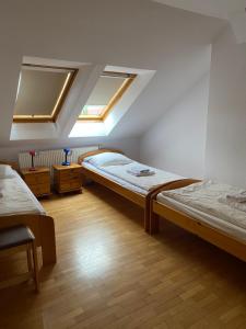 two beds in a room with two windows at Haus Panorama in Tylkowo