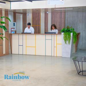 two people sitting at a counter in an office lobby at Rainbow Residence Batumi in Batumi +46 photos