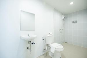 a white bathroom with a toilet and a sink at Snap Sukhumvit 1 - BTS Nana in Makkasan +32 photos