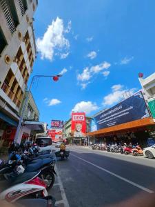 a group of motorcycles parked on a city street at We Hostel in Hat Yai