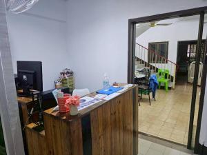 a room with a counter with a view of a living room at We Hostel in Hat Yai
