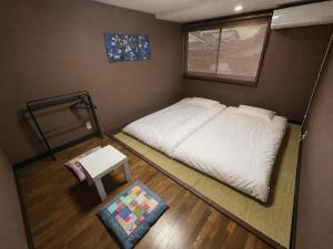 a small bedroom with a bed and a table at TAKIBEst Bnb&Bar in Takibe