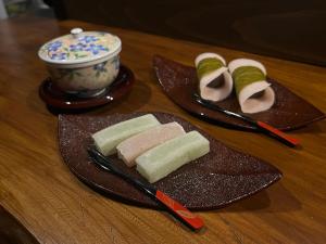 a table with two plates of food and a bowl at TAKIBEst Bnb&Bar in Takibe