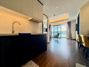 a kitchen with a sink and a living room at Luxury Ocean View Apartments - The Sapphire Ha Long, Studio & 2BR in Ha Long