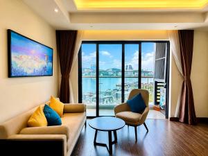 a living room with a couch and two chairs and a table at Luxury Ocean View Apartments - The Sapphire Ha Long, Studio & 2BR in Ha Long