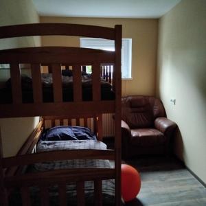a bedroom with two bunk beds and a couch at The Dacha apartment in Jūrmala