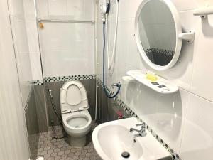 a small bathroom with a toilet and a sink at We Hostel in Hat Yai +25 photos