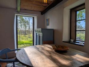 a wooden table with a bowl on it in a room with a window at Lillstugan på Lansa in Aurgrund
