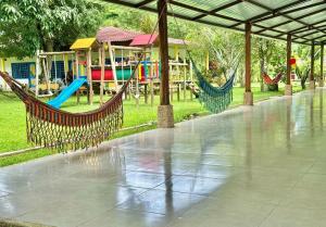 a playground with two hammocks and a play area at Finca Hotel La Potranca in Acacías