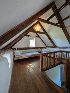 a attic room with a bed and a window at Lillstugan på Lansa in Aurgrund +16 photos
