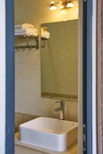 a bathroom with a sink and a mirror at Luxury Hotel Dalat in Xuan An