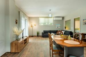 a kitchen and living room with a table and a couch at Elia Grove House in Néa Khilí