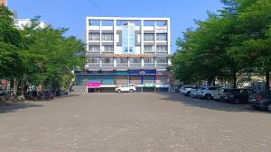 a large building with cars parked in front of it at Hotel Pride Executive in Satara