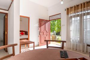 a room with a table and chairs and a door at Airport Green View Hotel Katunayake in Andiambalama +126 photos