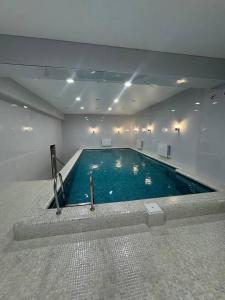 a large swimming pool in a large room at BOG'DON GRAND Hotel in Tashkent