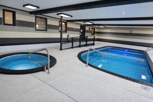 a large swimming pool in a building with a swimming pool at Super 8 by Wyndham Salina I-70 in Salina