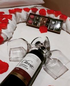 a bottle of wine on a table with a keychain at Chalés Terra dos Sonhos - Monte Verde in Monte Verde +5 photos