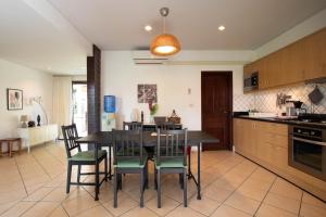 a kitchen with a dining room table and chairs at Garden Villa in Bali Residence Mae Phim with Kids Bunk Suite in Ban Bua Phut
